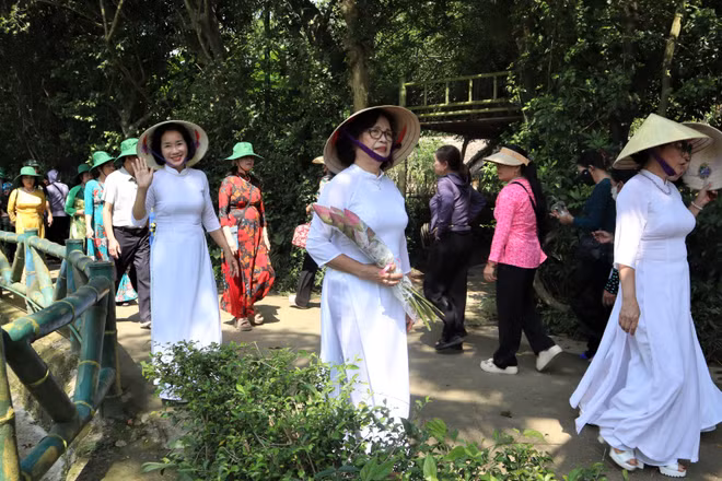 Người dân với những bó hoa sen, hoa huệ, thành kính dâng lên Người.