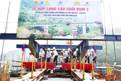 Lãnh đạo tỉnh Lào Cai, chủ đầu tư và đơn vị thi công thực hiện nghi thức hợp long cầu Suối Đum 2 trên cao tốc Lào Cai-Sa Pa.