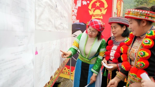 Cử tri đồng bào dân tộc thiểu số nghiên cứu danh sách những người ứng cử niêm yết tại đơn vị bầu cử số 1, xã Bằng Thành. (Ảnh: THÁI SƠN).