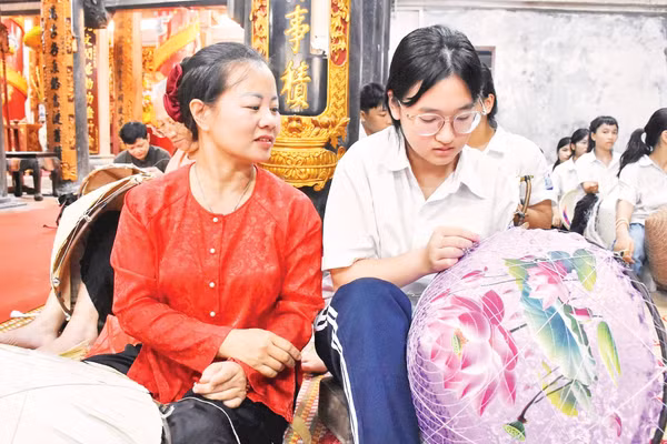 Truyền dạy nghề làm nón lá tại Trung tâm Học tập cộng đồng xã Thanh Oai. Ảnh: Thảo Phạm