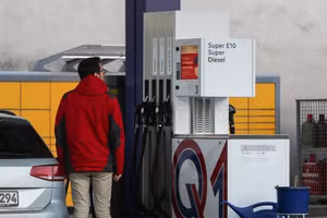 Người đàn ông nhìn vào bảng giá nhiên liệu tại 1 trạm xăng ở thủ đô Berlin, Đức. (Ảnh: THX)