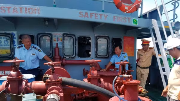 Cán bộ quản lý thị trường (áo xanh) đang kiểm tra một tàu chứa dầu nhưng không có giấy tờ chứng minh nguồn gốc hàng hóa. 