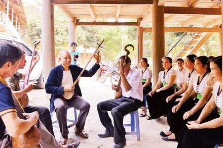 Ông Điện hướng dẫn các thành viên trong câu lạc bộ của bản Nậm Ty cách chơi đàn tính.