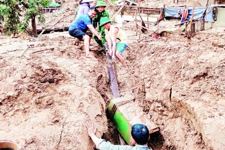 Cán bộ, chiến sĩ Đồn Biên phòng Mỹ Lý, tỉnh Nghệ An cùng các lực lượng tại chỗ giúp đỡ nhân dân trên địa bàn.