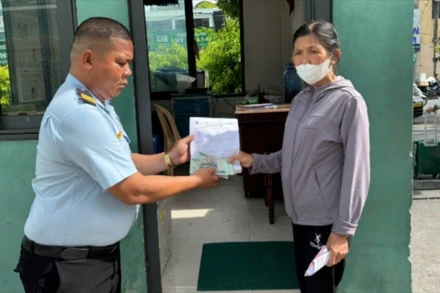 Bảo vệ tại Bệnh viện Đà Nẵng trao lại số tiền nhặt được cho bà Võ Thị Tiếng. (Ảnh: Bệnh viện Đà Nẵng cung cấp)