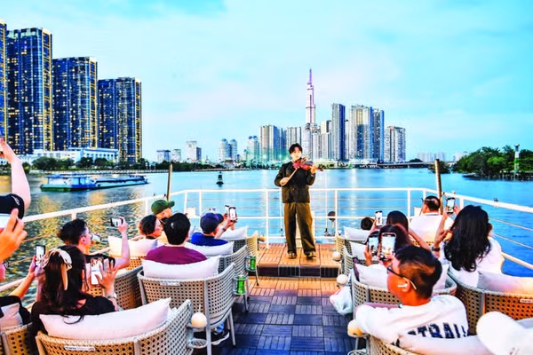 Khách du lịch trong nước và nước ngoài trải nghiệm buýt trên sông Sài Gòn vào ban đêm. (Ảnh: THÀNH ĐẠT)