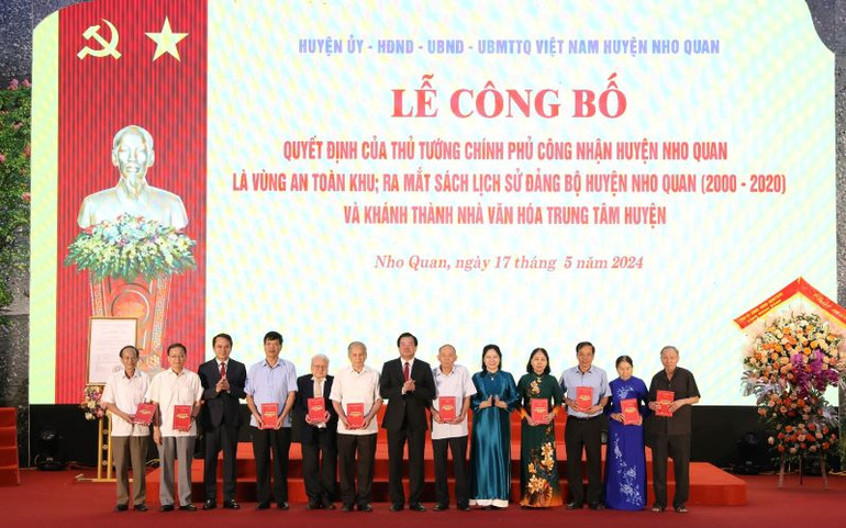 Thường trực Huyện ủy Nho Quan tặng sách "Lịch sử Đảng bộ huyện Nho Quan (2000-2020) cho các cán bộ lão thành. Ảnh: ĐỨC PHƯƠNG
