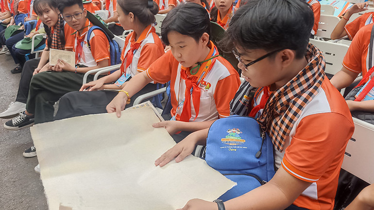 Các em thiếu nhi tìm hiểu về giấy dó.