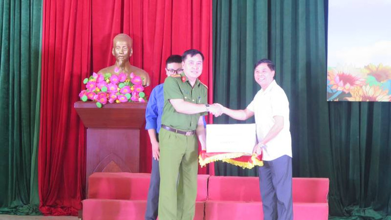 Đại diện lãnh đạo Sở Văn hoá, Thể thao và Du lịch tỉnh Lạng Sơn, tặng sách cho đại diện lãnh đạo Trại tạm giam Công an tỉnh.