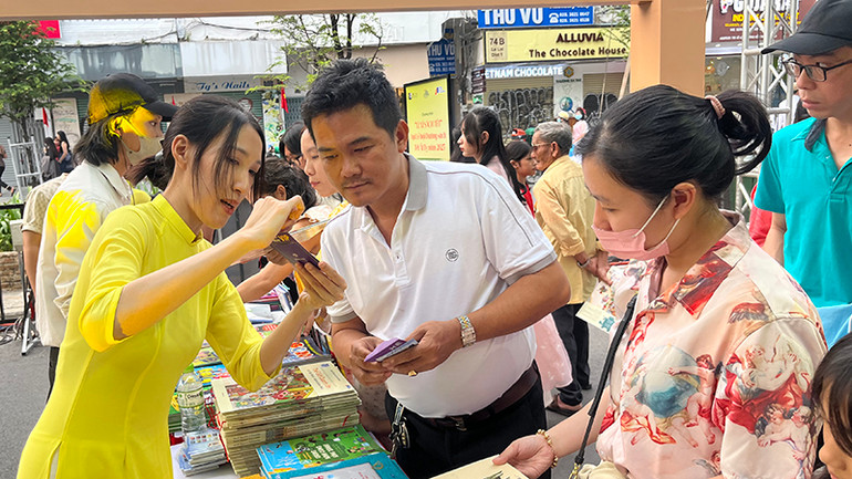 Nhân viên hướng dẫn du khách cách sử dụng khi được nhận lì xì tài khoản sách nói.