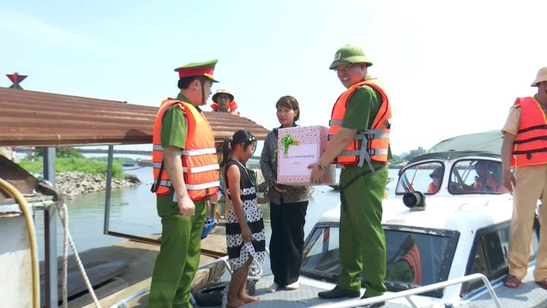 Đại tá Tống Như Sơn, Phó Giám đốc, Thủ trưởng cơ quan Cảnh sát điều tra công an tỉnh Ninh Bình cùng đoàn công tác trao quà hỗ trợ người dân trên sông Đáy. (Ảnh: ĐỨC THẮNG)