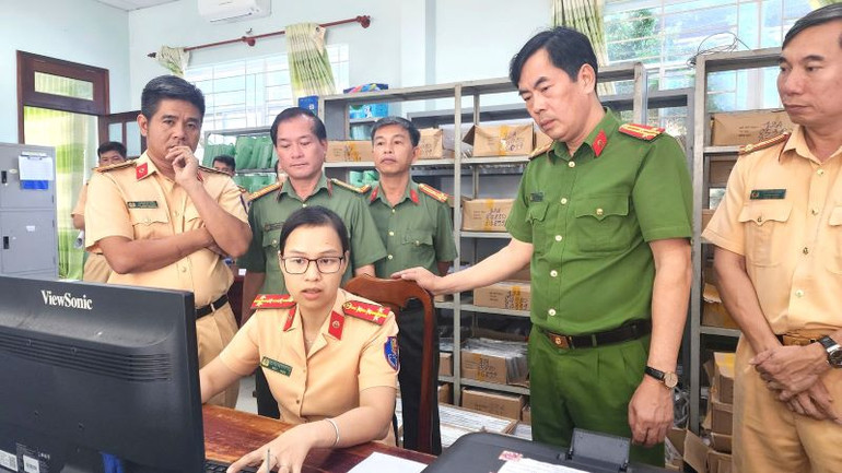 Thượng tá Trần Thanh Hiển, Phó Giám đốc Công an tỉnh (áo xanh) kiểm tra quy trình nghiệp vụ tại Phòng Cảnh sát giao thông tỉnh về thủ tục cấp Giấy phép lái xe.