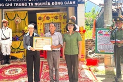 Thừa ủy quyền của Chủ tịch nước, Thiếu tướng Ngô Hoài Thu, Phó Cục trưởng Cục Công tác chính trị, Bộ Công an đã trực tiếp trao tặng Huân chương Bảo vệ Tổ quốc hạng Ba cho thân nhân đồng chí Nguyễn Đông Cánh tại gia đình. (Ảnh: VĂN THÀNH)