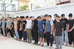 Các đối tượng trong đường dây lừa đảo bị bắt giữ. (Ảnh: CANA)