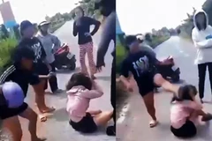 Cháu N (áo hồng) bị nhóm người vây đánh rất dã man (ảnh cắt từ video)