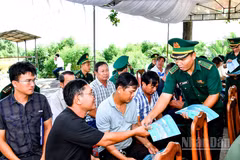 Cán Bộ đồn Biên phòng Trung Bình cấp phát tờ rơi tuyên truyền chống khai thác IUU cho bà con ngư dân tham dự lễ ra quân.