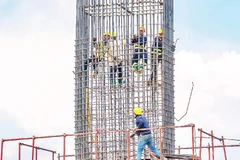 Các kỹ sư, công nhân đang khẩn trương thi công trụ dẫn của dự án cầu Đại Ngãi 1 bắc qua sông Hậu.