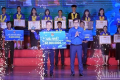 Đồng chí Bùi Quang Huy, Ủy viên dự khuyết Trung ương Đảng, Bí thư Thứ nhất Trung ương Đoàn (bên phải) trao giải nhất Cuộc thi tặng đại diện dự án "Cà Mèn".
