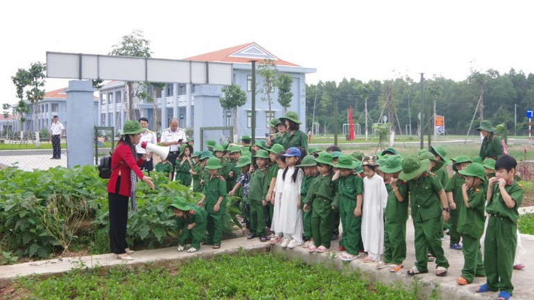 Các em học sinh tham quan vườn tăng gia sản xuất của đơn vị.