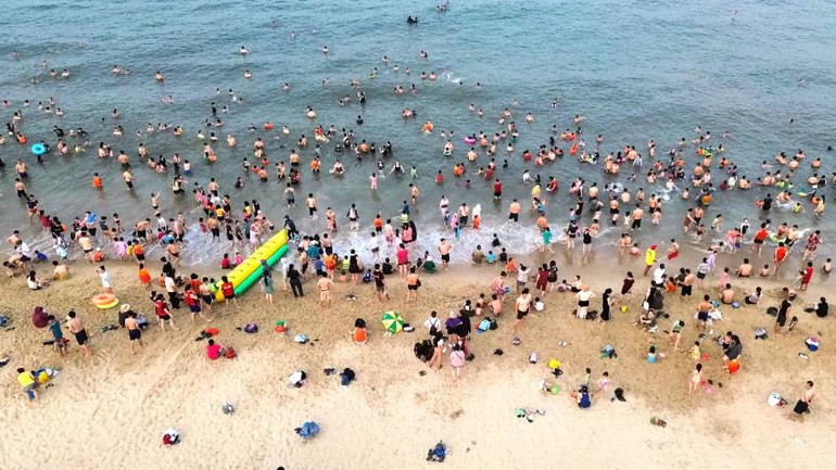 Bãi biển Nhật Lệ (Quảng Bình) thu hút đông du khách đến tắm mát mỗi sáng, mỗi chiều