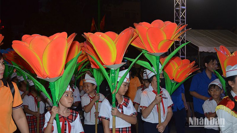 Học sinh trường tiểu học, THCS và THPT Lê Quý Đôn rước lồng đèn nhỏ với hình ảnh logo năm Du lịch quốc gia 2023 “ Bình Thuận - Hội tụ xanh”.