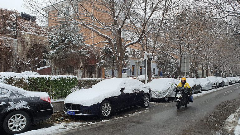 Một người dân di chuyển bằng xe đạp điện trong gió tuyết mạnh. Một người dân di chuyển bằng xe đạp điện trong gió tuyết mạnh.