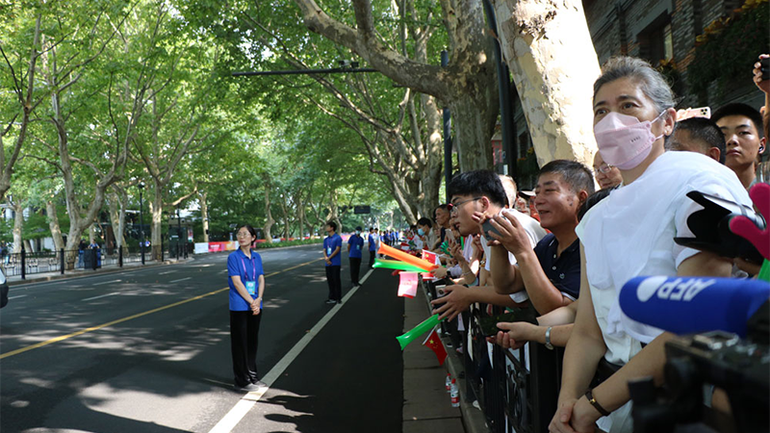 Nhiều người dân và khách du lịch đứng hai bên đường xem rước đuốc ASIAD 19. (Ảnh: people.com.cn)