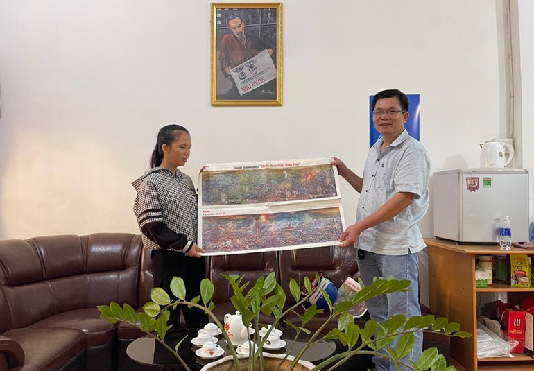 Nhà báo Nguyễn Công Lý, Trưởng Văn phòng Đại diện Báo Nhân Nhân tại Đắk Lắk trao tặng phụ san tranh panorama “Chiến dịch Điện Biên Phủ” cho các em sinh viên Trường Đại học Tây Nguyên.