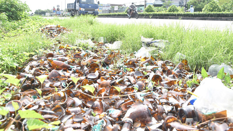 Vỏ chai bia bị bể nằm dọc một đoạn trên quốc lộ 1.