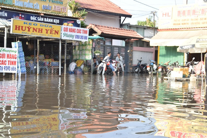 Triều cường gây ngập tại Vòng xoay Trung Lương, thành phố Mỹ Tho (Tiền Giang) vào chiều 11/3.
