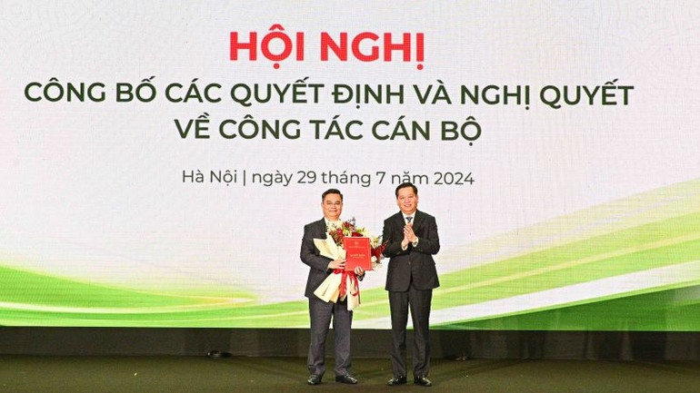 Ông Nguyễn Long Hải (bên phải) trao Quyết định và tặng hoa chúc mừng tân Bí thư Đảng ủy Vietcombank Nguyễn Thanh Tùng.