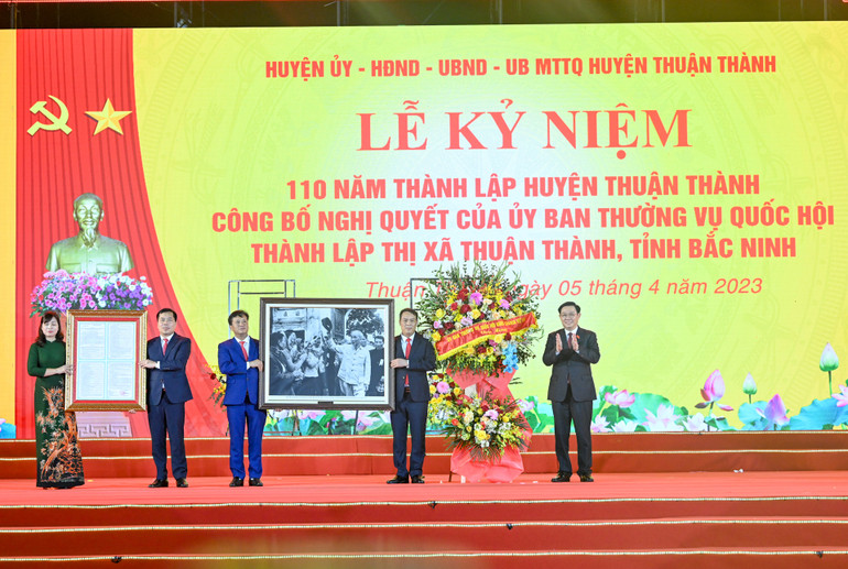 Chủ tịch Quốc hội Vương Đình Huệ trao quà lưu niệm và tặng hoa chúc mừng thị xã Thuận Thành.