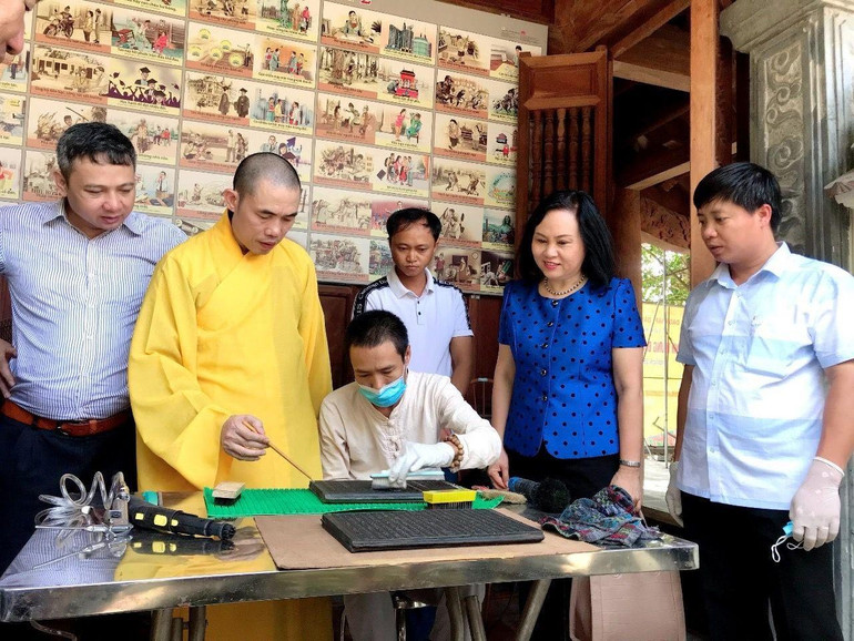 Cán bộ Trung tâm Lưu trữ quốc gia IV hỗ trợ chùa Vĩnh Nghiêm (Bắc Giang) bảo quản Mộc bản cổ tại đây. Ảnh: NVCC