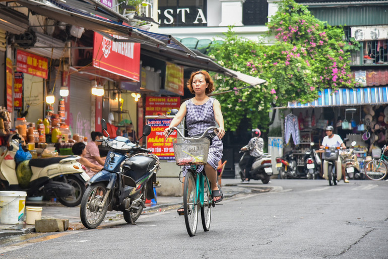 Người dân đạp xe đi chợ từ sớm để chuẩn bị mâm cúng Tết Đoan Ngọ, thời tiết sáng nay rất quang đãng và mát mẻ, thích hợp cho việc mua bán tại chợ.