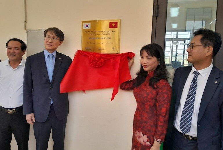 Đại diện dự án và nhà trường thực hiện nghi thức gắn biển phòng máy tính.