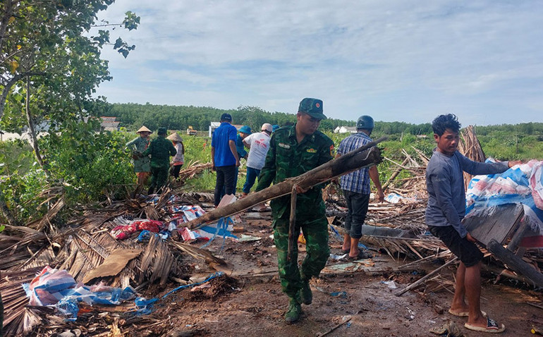 Cán bộ, chiến sĩ đồn Biên phòng cùng các lực lượng giúp dân khắc phục hậu quả thiên tai.