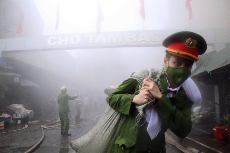 Lực lượng chức năng đã điều động hơn 20 xe chữa cháy và hàng trăm cán bộ, chiến sĩ đến hiện trường triển khai các phương án khống chế, không cho đám cháy lan sang khu vực các nhà bên cạnh; đồng thời sơ tán người dân ra khỏi khu vực cháy, cứu tài sản cho người dân, sẵn sàng cứu thương khi có sự cố. (Ảnh: Hoàng Ngọc/TTXVN)