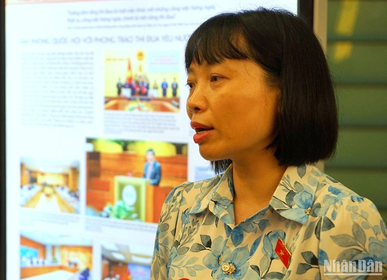 Đại biểu Nguyễn Thị Việt Nga (Hải Dương) trao đổi với phóng viên bên hành lang Quốc hội. (Ảnh: TRUNG HƯNG)