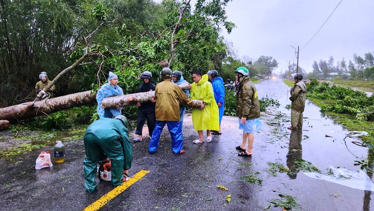 Lực lượng công an dọn dẹp cây xanh gãy đổ trên đường.