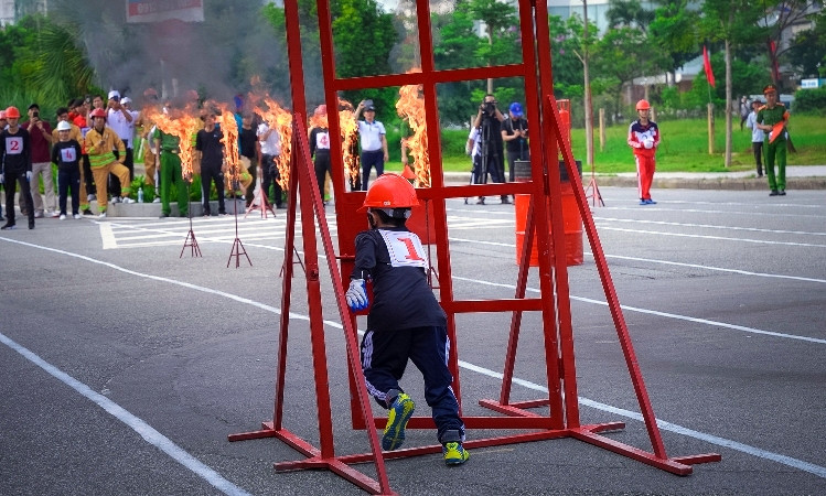 Các đội tham gia phần thi gia đình tiếp sức 4x50m chữa cháy, di chuyển tài sản.