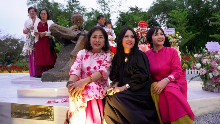 Các nghệ sỹ, bạn bè, thân hữu gia đình cố nhạc sĩ Trịnh Công Sơn chụp ảnh lưu niệm bên tượng Trịnh Công Sơn.