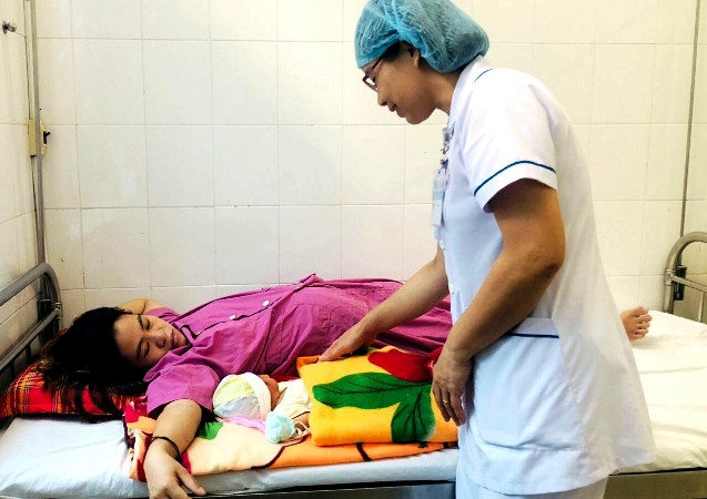 Hai mẹ con chị Đoàn Thị Th. được được các y bác sĩ Bệnh viện Phong Điền chăm sóc sau mổ.