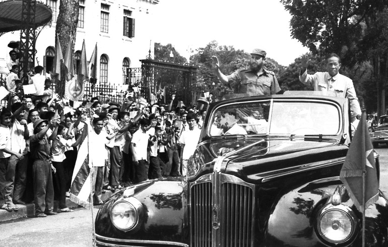 Đồng chí Fidel Castro đến Hà Nội. Bên cạnh là dồng chí Lê Duẩn cùng đứng vẫy chào đông đảo nhân dân Thủ đô náo nức chờ đón suốt dọc đường.