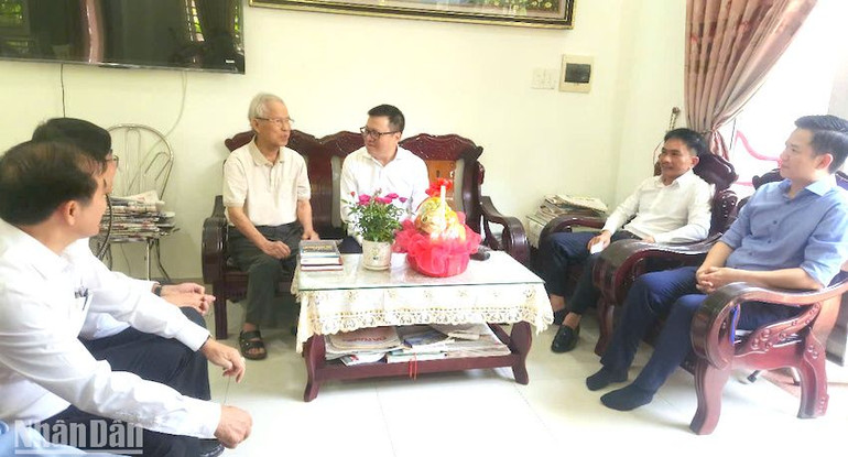 Đồng chí Lê Quốc Minh và nhà báo lão thành Hồ Duy Lệ trao đổi về nghề báo hiện nay. (Ảnh: ĐÌNH TĂNG)