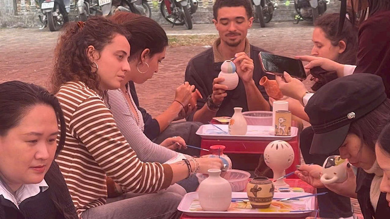 Du khách nước ngoài trải nghiệm nghề thủ công truyền thống ở Côn Sơn.