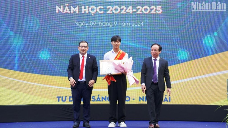 PGS, TS Nguyễn Ngọc Vũ, Giám đốc Đại học Đà Nẵng và PGS, TS Nguyễn Hữu Hiếu, Hiệu trưởng Trường đại học Bách khoa trao học bổng vinh danh tân sinh viên Phan Tấn Sơn (đạt 28,55 điểm), ngành Công nghệ thông tin (Đặc thù - Hợp tác doanh nghiệp), chuyên ngành Khoa học dữ liệu và Trí tuệ nhân tạo với học bổng trị giá 40 triệu đồng. (Ảnh: ANH ĐÀO)