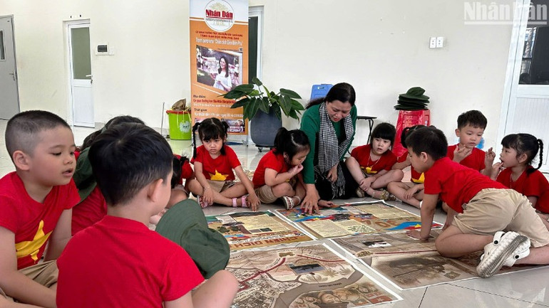 Nằm trong chương trình hoạt động ý nghĩa này, cô trò Trường mầm non Ngọc Lan còn có buổi tham quan, tìm hiểu lịch sử Chiến dịch Hồ Chí Minh qua ấn phẩm phụ san đặc biệt của Báo Nhân Dân trao tặng. (Ảnh: ANH ĐÀO)