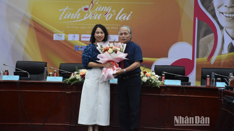 Nghệ sĩ Ưu tú Nguyễn Thị Hội An, Phó Giám đốc Sở Văn hóa, thể thao thành phố Đà Nẵng tặng hoa cảm ơn nhạc sĩ Phan Hồng Hà - con trai nhạc sĩ Phan Huỳnh Điểu. (Ảnh: ANH ĐÀO)