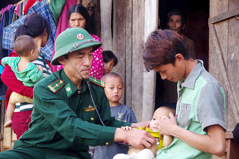 Cán bộ quân y Đồn Biên phòng Pa Ủ, Bộ đội Biên phòng tỉnh Lai Châu khám bệnh cho bà con dân tộc La Hủ, xã Pa Ủ, huyện Mường Tè, tỉnh Lai Châu). Ảnh: TTXVN