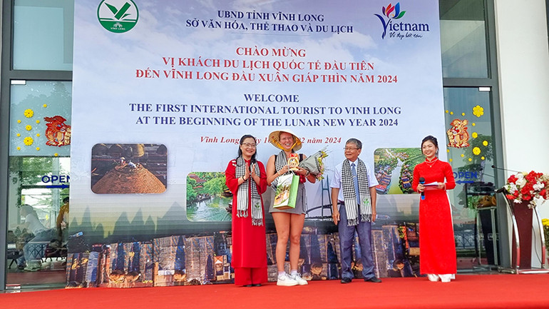 Lãnh đạo tỉnh Vĩnh Long tặng quà lưu niệm cho vị khách quốc tế đầu tiên đến Vĩnh Long.